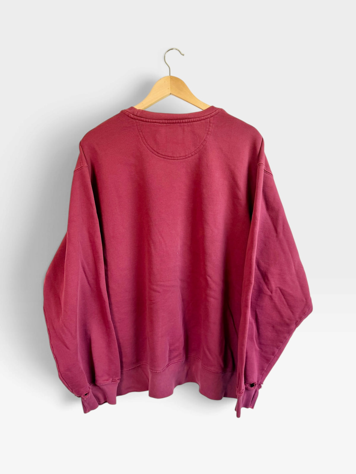 225 Threadz vintage Eddie Bauer burgundy crewneck sweatshirt showing the plain back view on a wooden hanger.