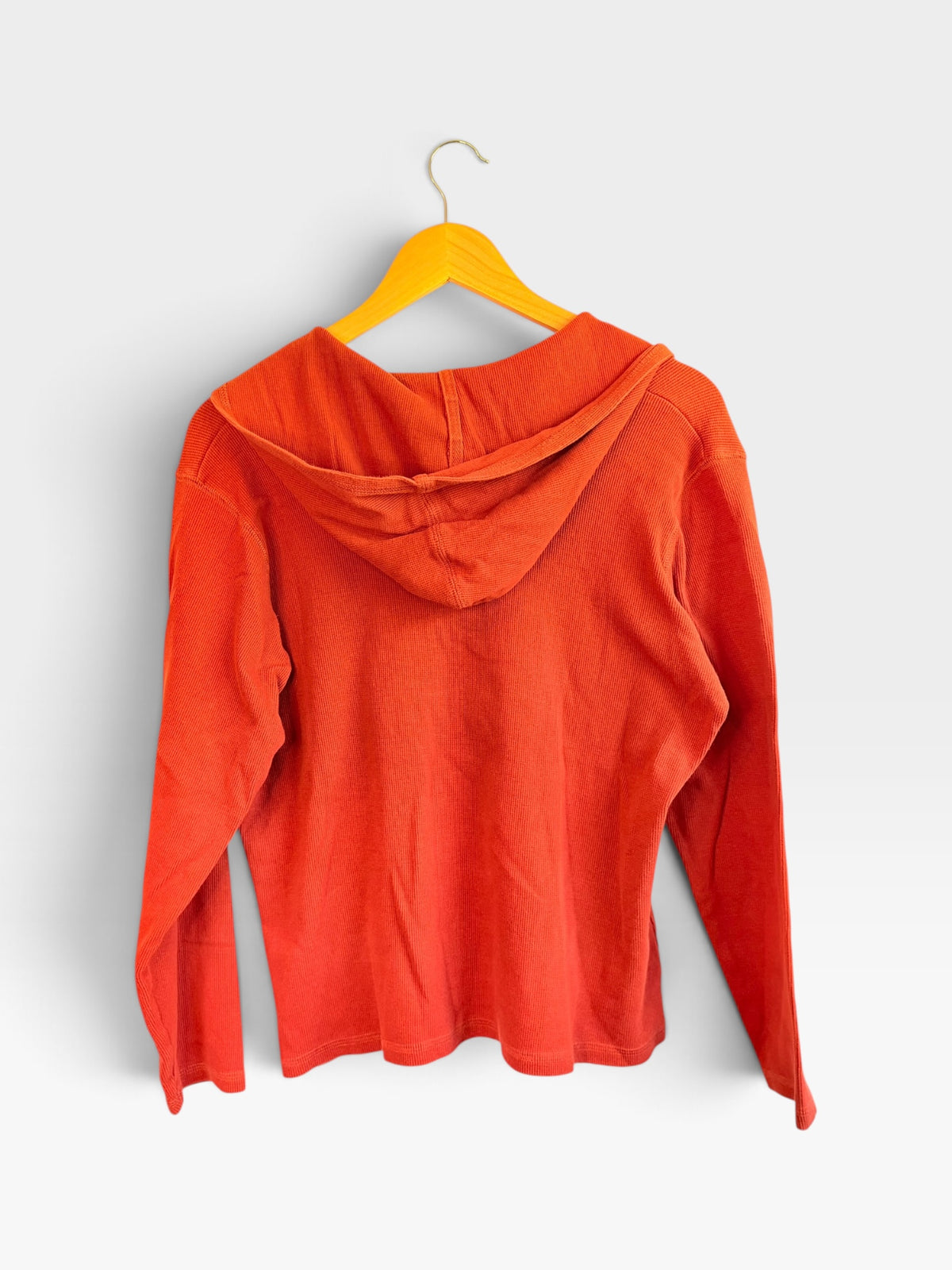 Back view of a 225 Threadz Harley-Davidson burnt orange waffle-knit long sleeve hooded pullover shirt on a hanger.