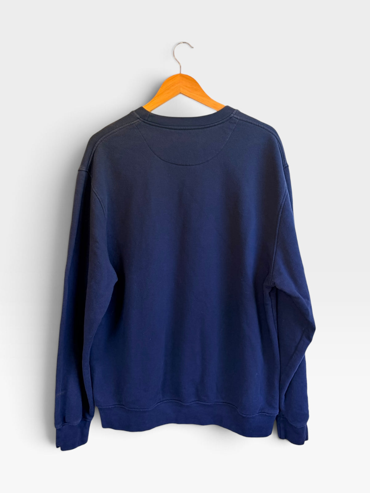 225 Threadz navy blue Nike crewneck sweatshirt hanging on a wooden hanger against a plain white background