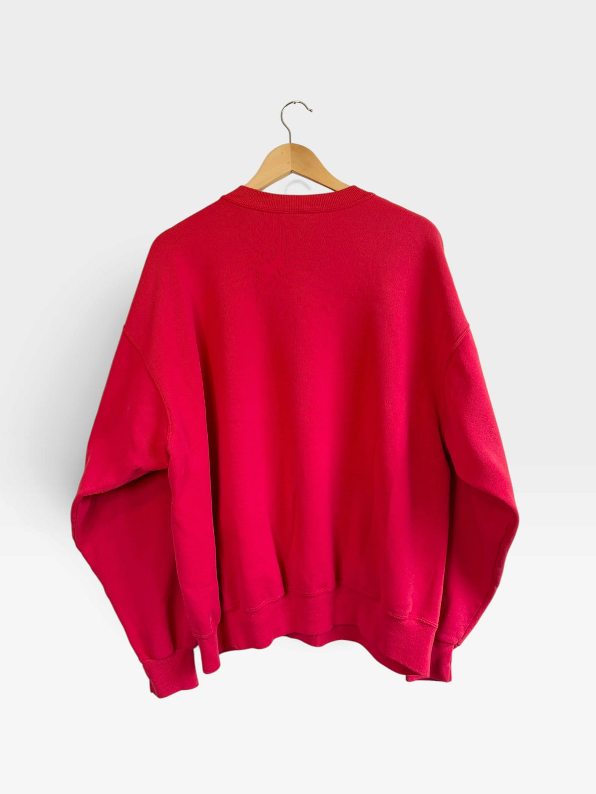 225 Threadz vintage-inspired red Kansas City Chiefs crewneck sweatshirt, back view on a wooden hanger.