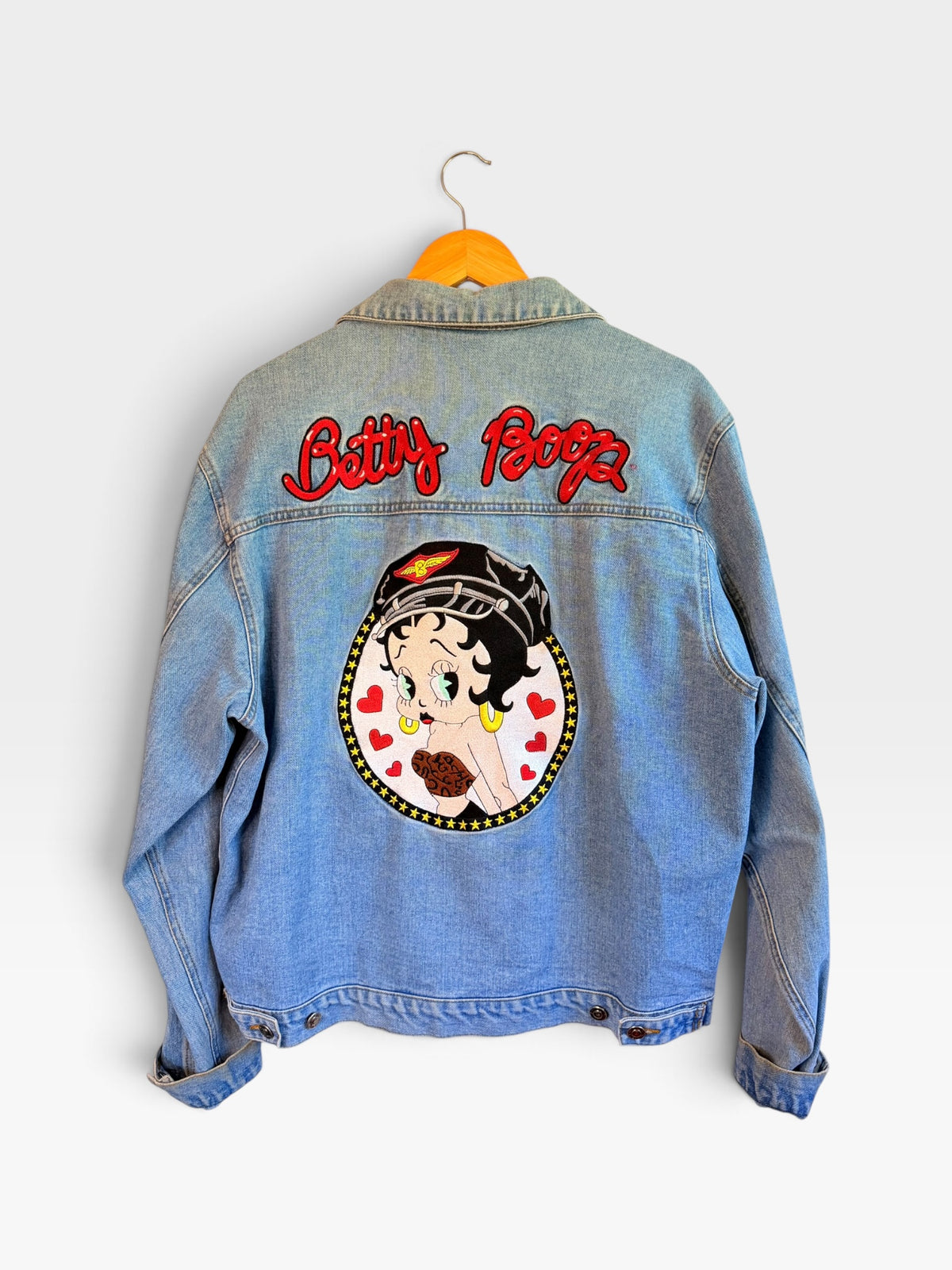 225 Threadz light-wash denim jacket featuring a large embroidered Betty Boop graphic on the back with red lettering.