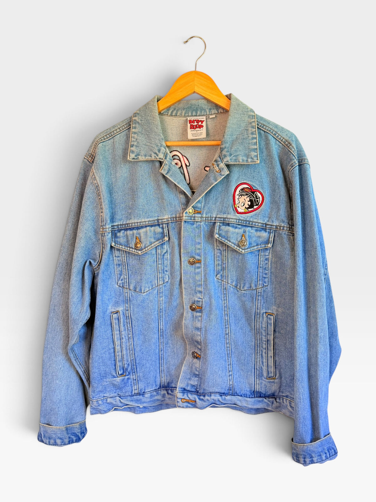 225 Threadz light-wash denim jacket featuring a Betty Boop heart patch on the chest and a classic button-up design.