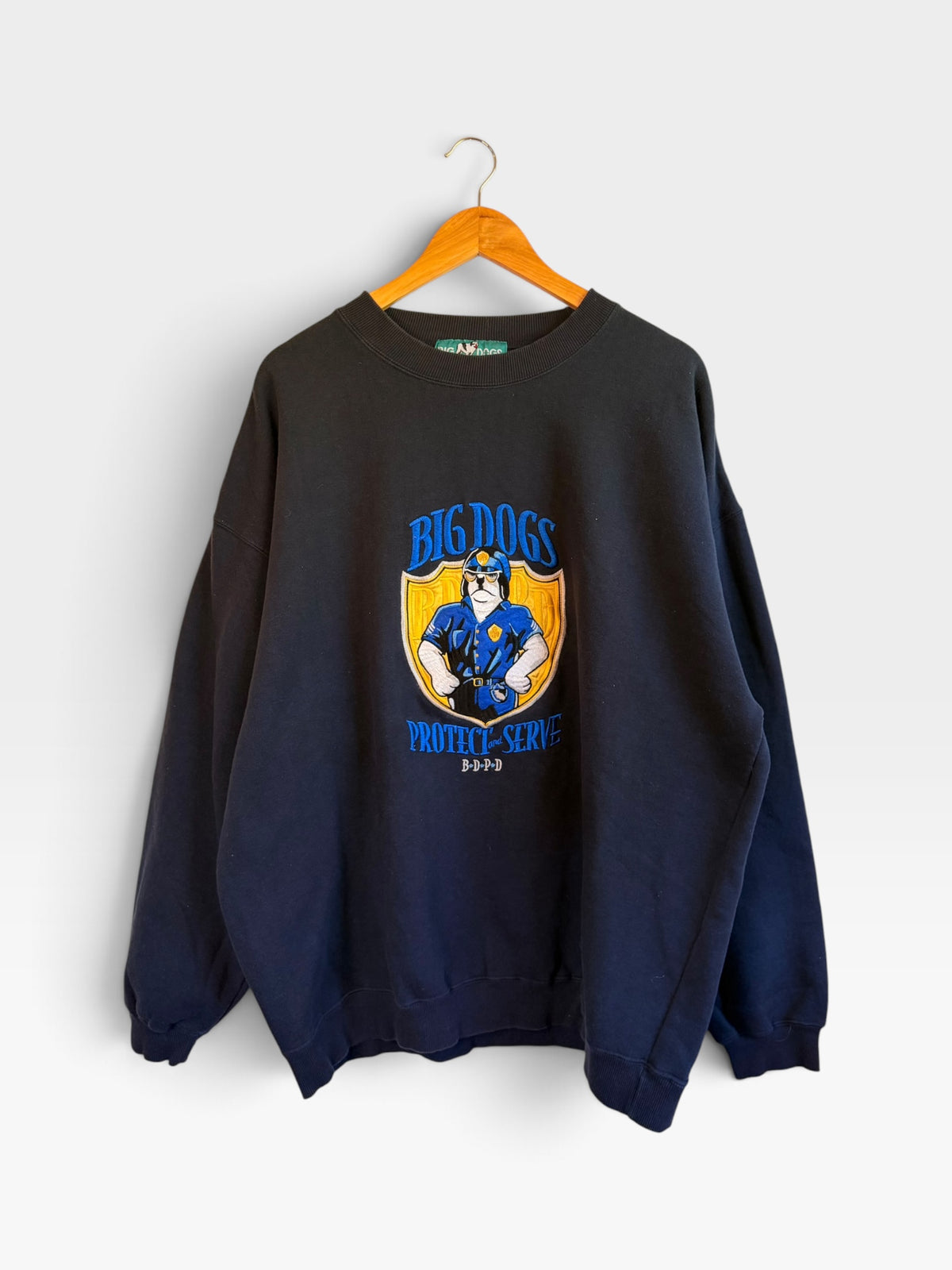 225 Threadz black Big Dogs graphic crewneck sweatshirt with Protect and Serve police dog print on a wooden hanger