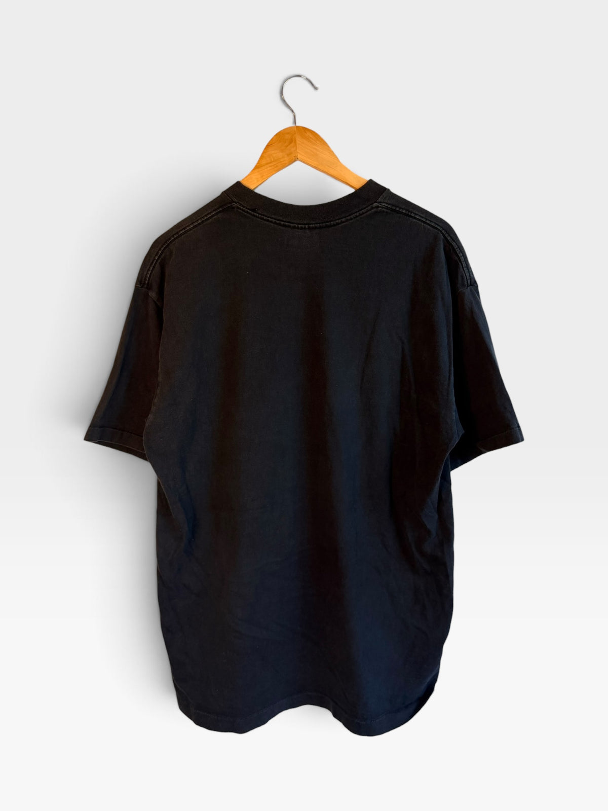 Back view of a 225 Threadz vintage-inspired black cotton crewneck t-shirt hanging on a wooden hanger.