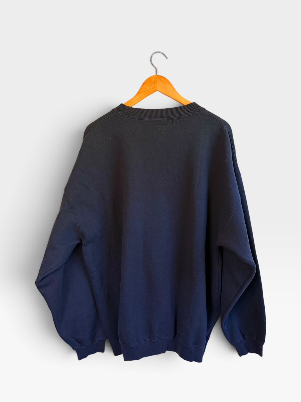 225 Threadz black crewneck sweatshirt hanging on a wooden hanger showing the plain back view