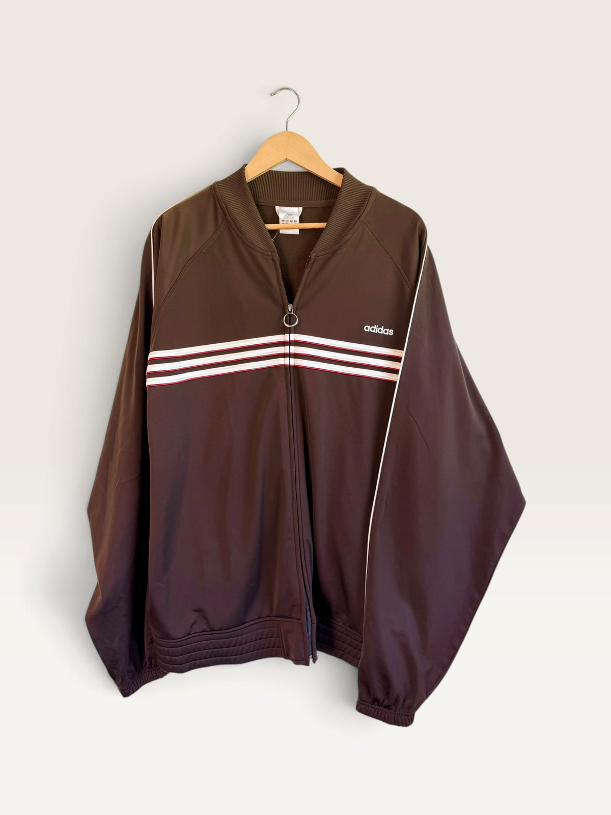 225 Threadz vintage brown Adidas track jacket with white and maroon chest stripes and a full zip ring pull closure.