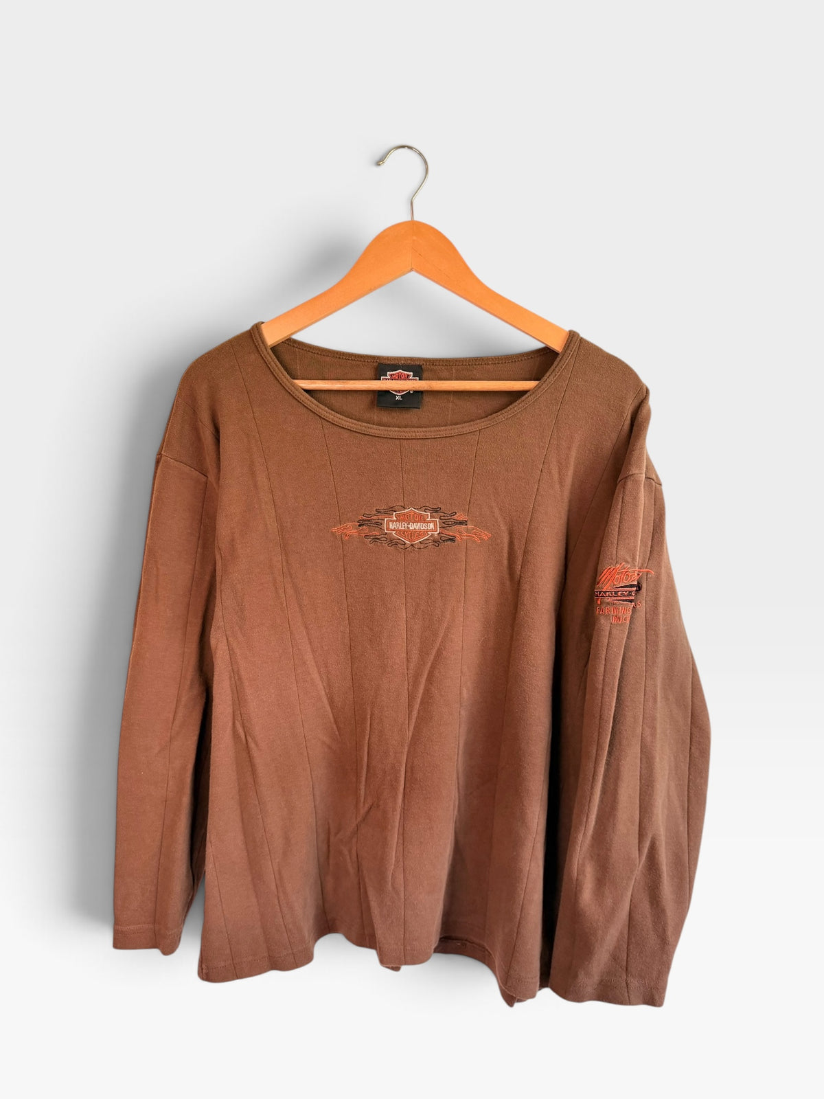 225 Threadz brown Harley-Davidson long sleeve crewneck shirt with orange and black flame embroidery on a hanger