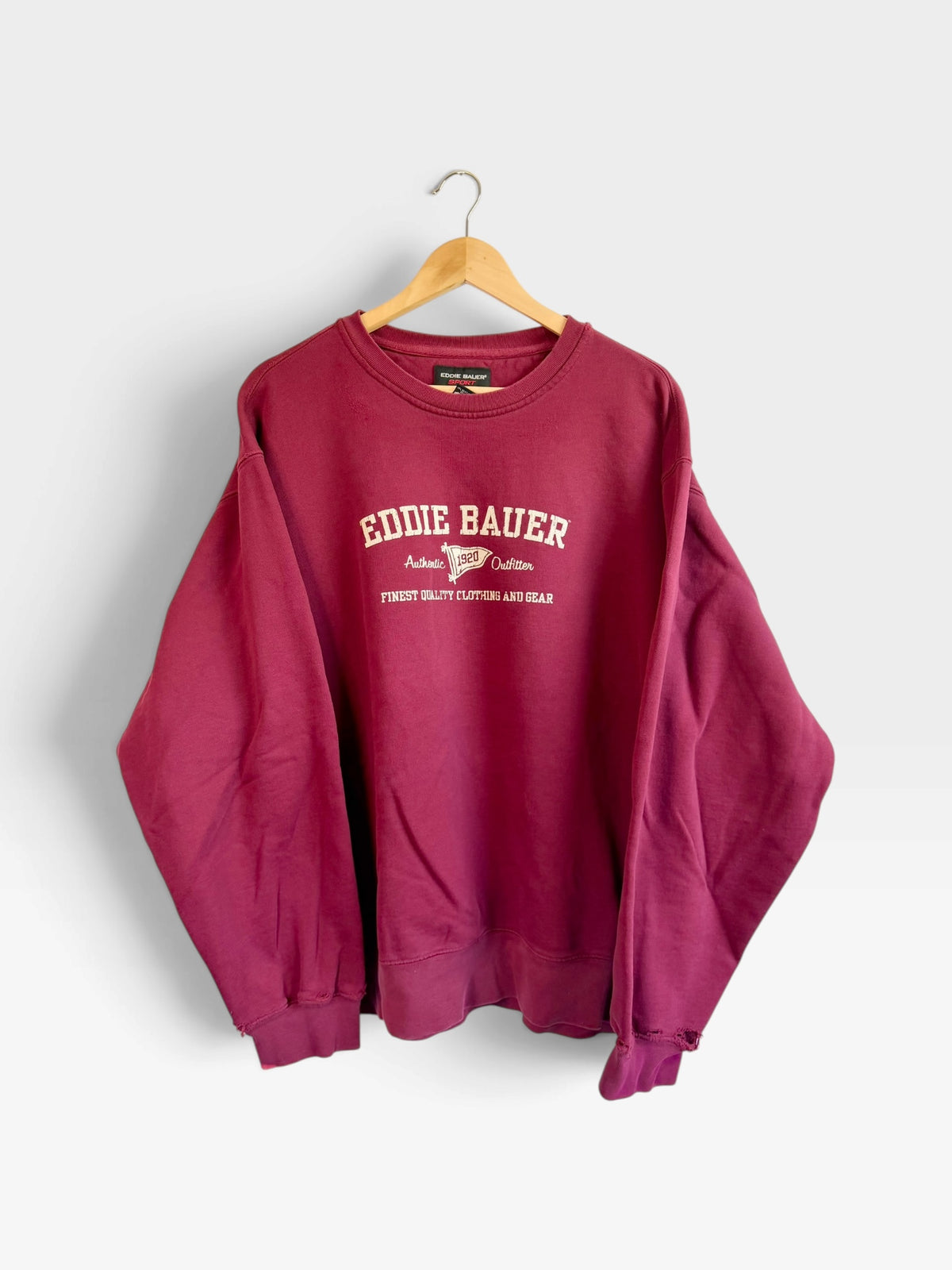 225 Threadz vintage-style burgundy Eddie Bauer crewneck sweatshirt with embroidered heritage logo on a wooden hanger
