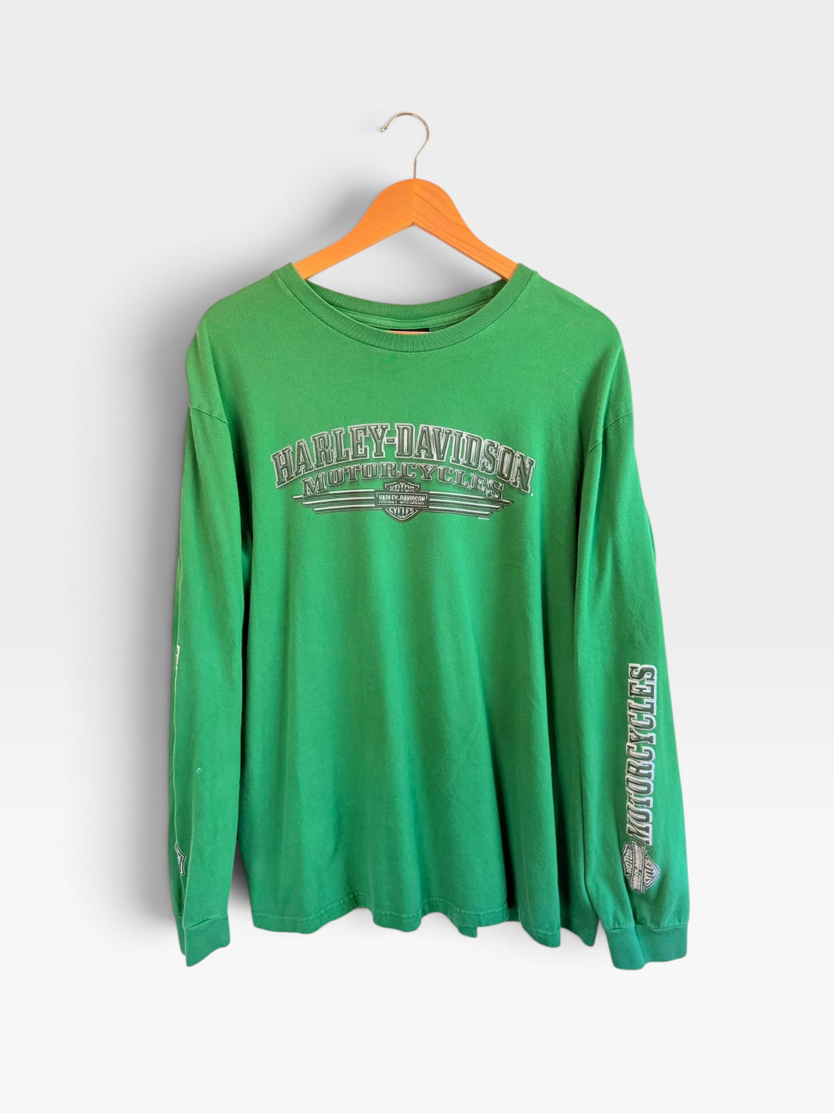 225 Threadz green Harley-Davidson long sleeve graphic t-shirt with crew neck on a wooden hanger