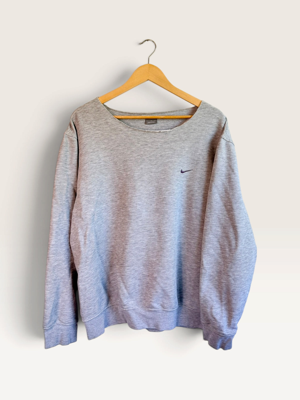 225 Threadz grey Nike long sleeve crewneck sweatshirt with embroidered swoosh logo on a wooden hanger