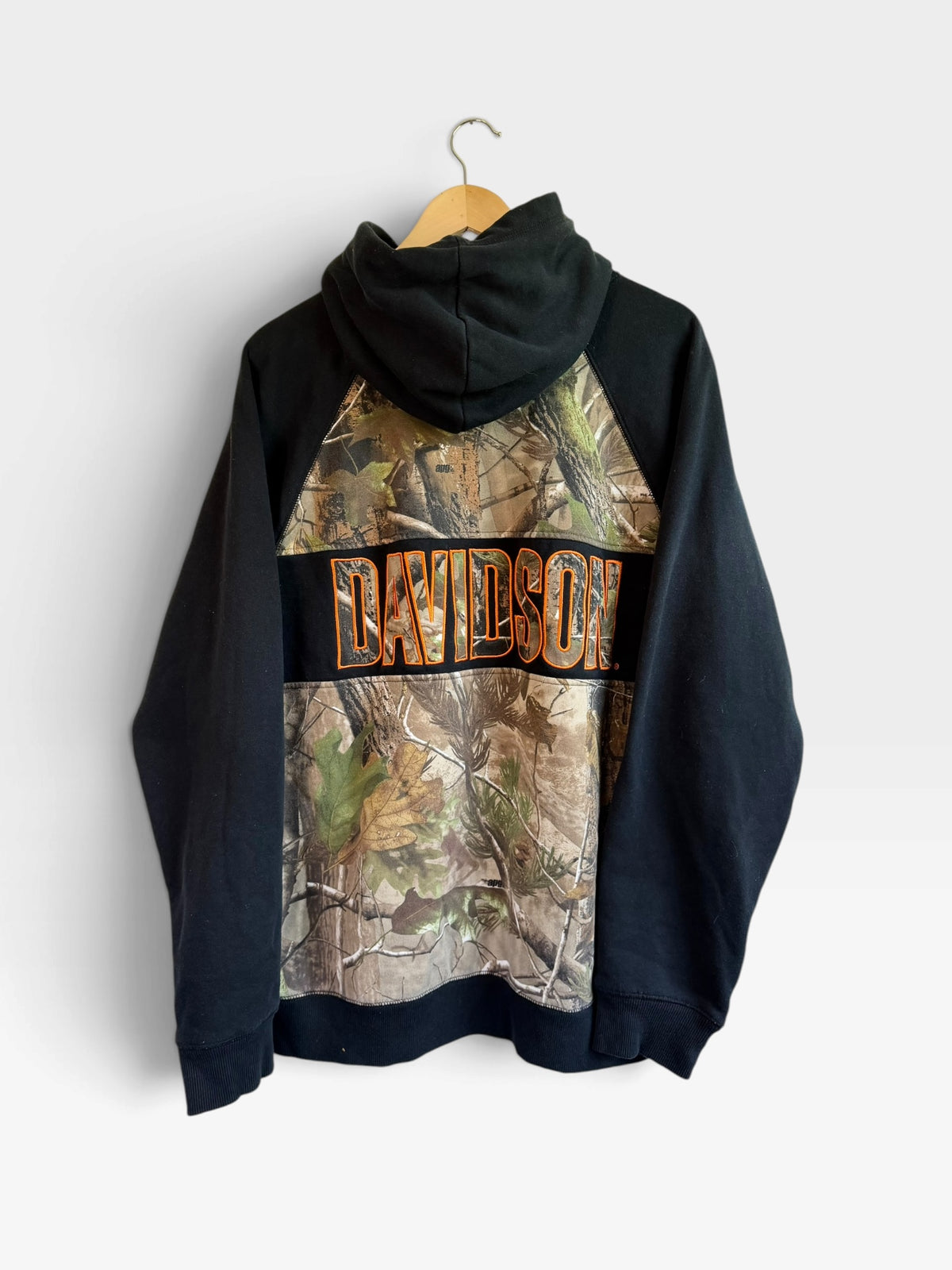 225 Threadz Harley-Davidson pullover hoodie with black sleeves and woodland camouflage back featuring orange lettering