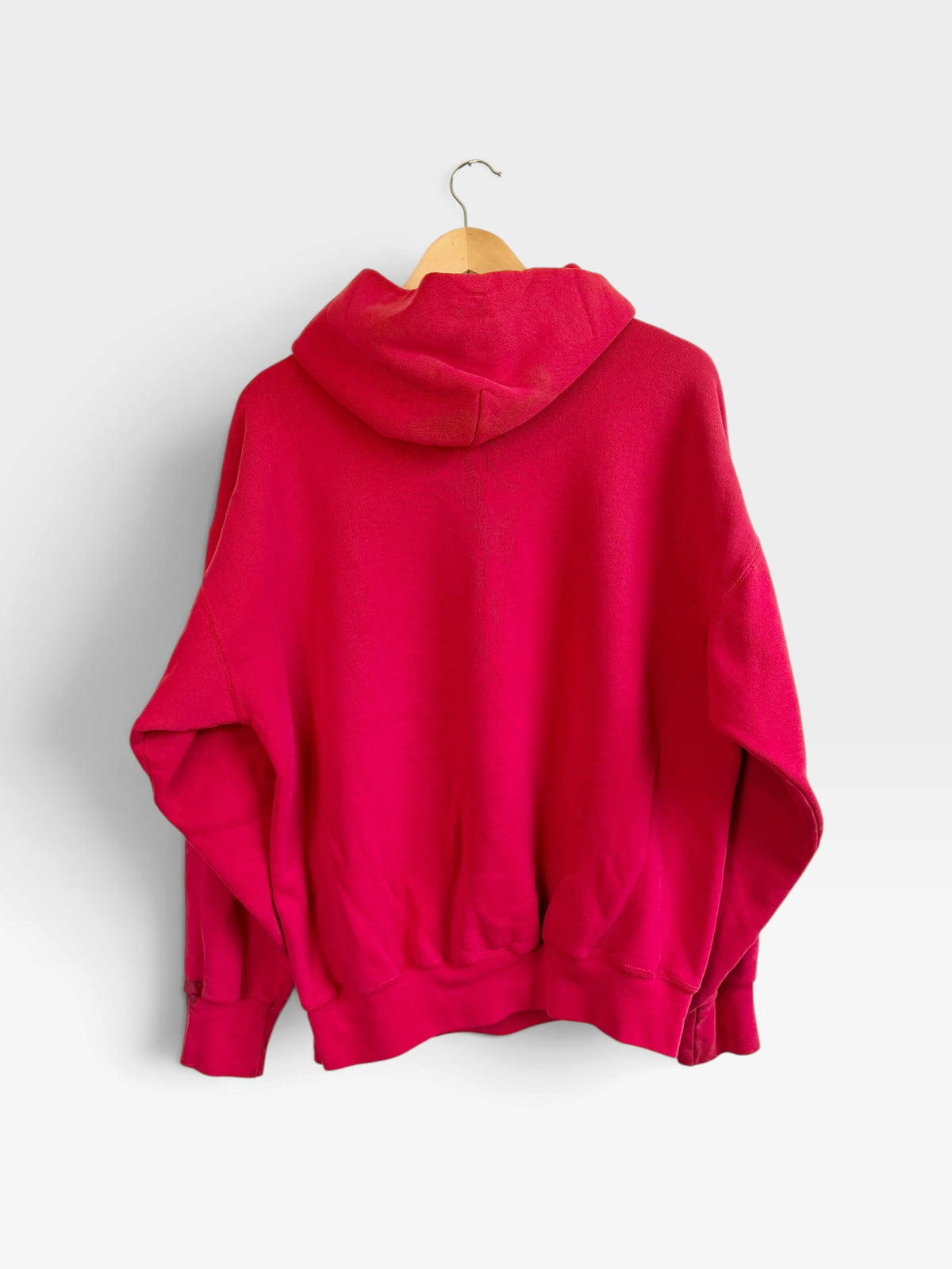Back view of a vibrant red 225 Threadz Kansas City Chiefs pullover hoodie hanging on a wooden hanger.