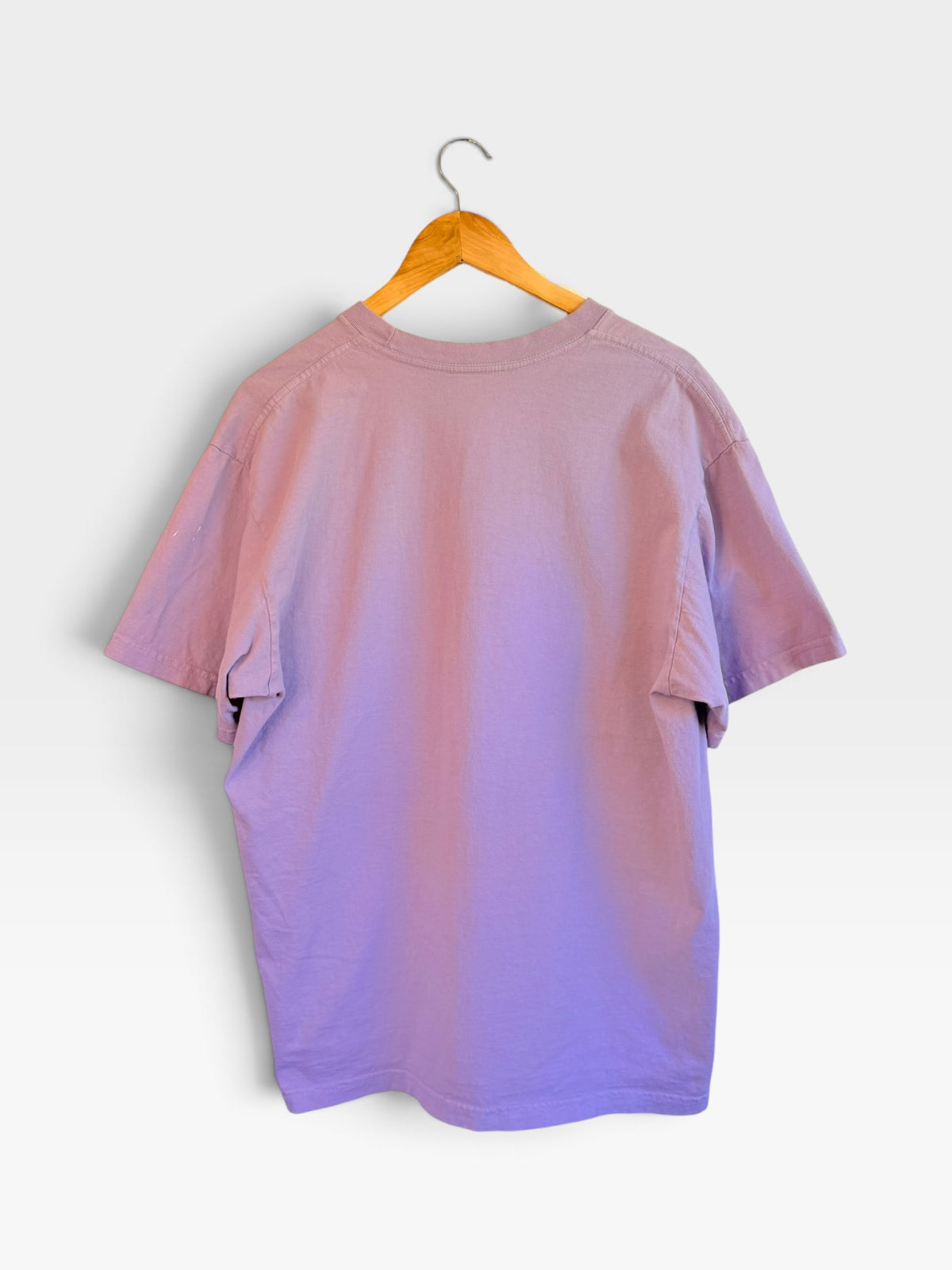225 Threadz lavender cotton crewneck t-shirt hanging on a wooden hanger, back view.