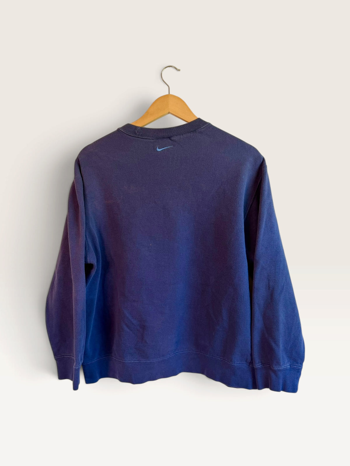 225 Threadz vintage navy blue Nike crewneck sweatshirt featuring a small embroidered Swoosh on the back neckline.