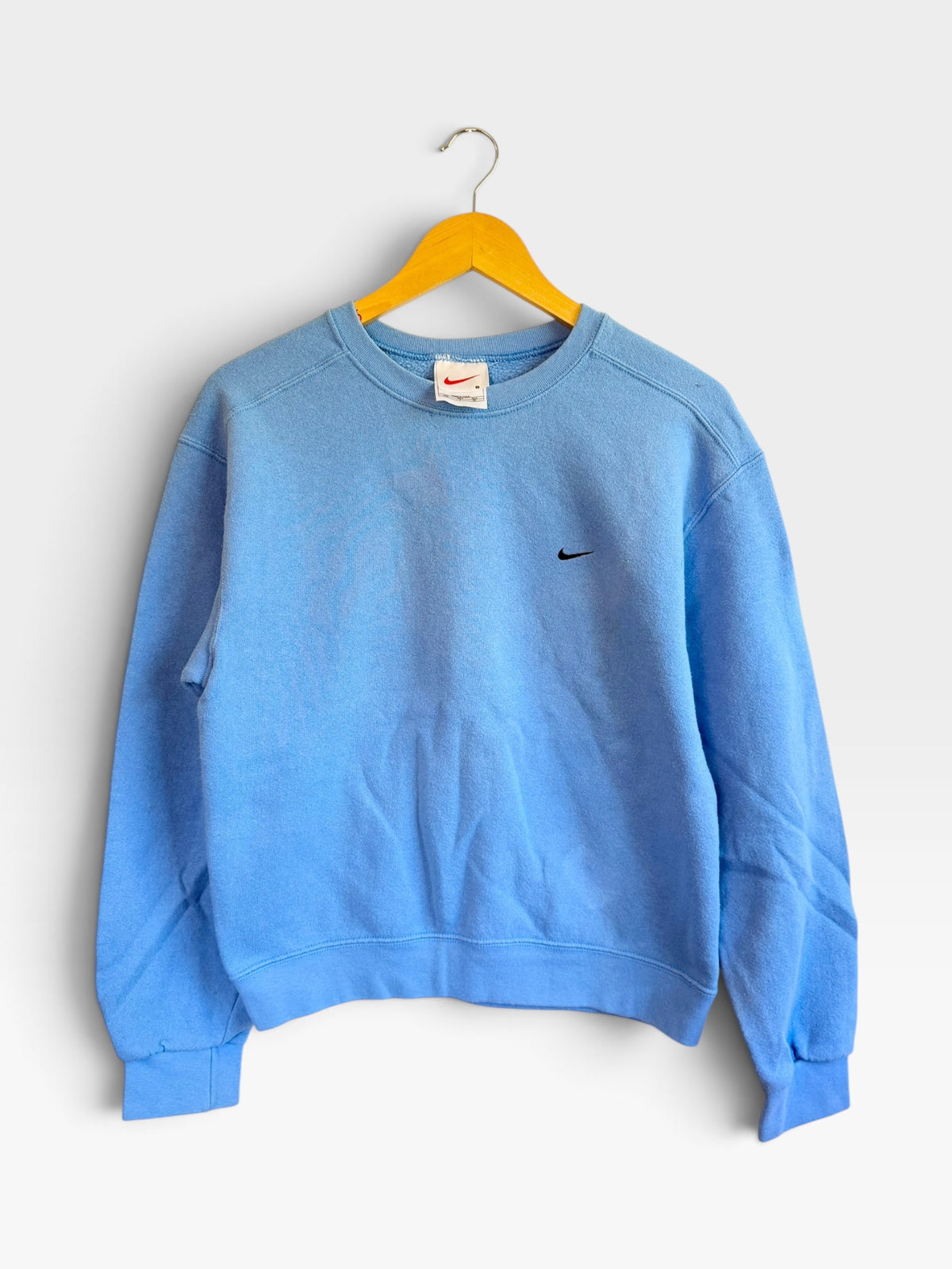 225 Threadz light blue Nike vintage crewneck sweatshirt with embroidered swoosh on a yellow hanger