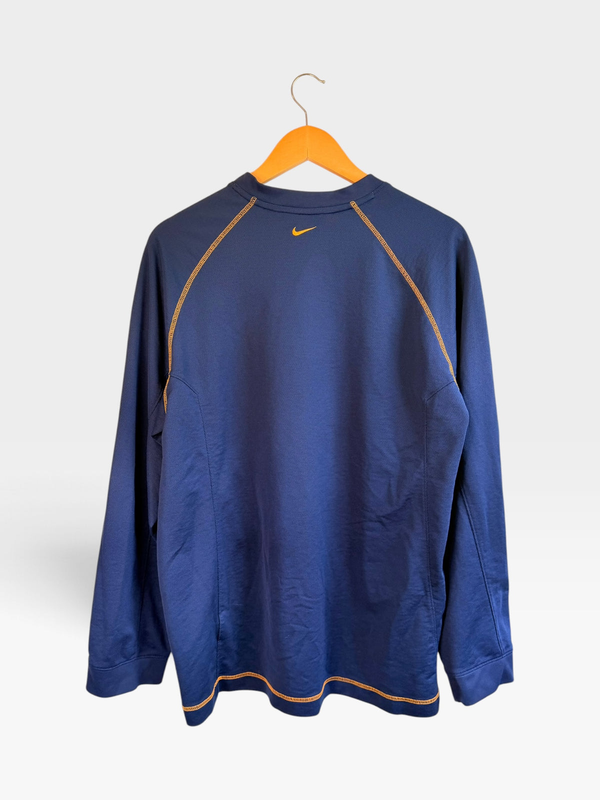 225 Threadz navy blue Nike Athletics long sleeve pullover with gold contrast stitching and back Swoosh logo
