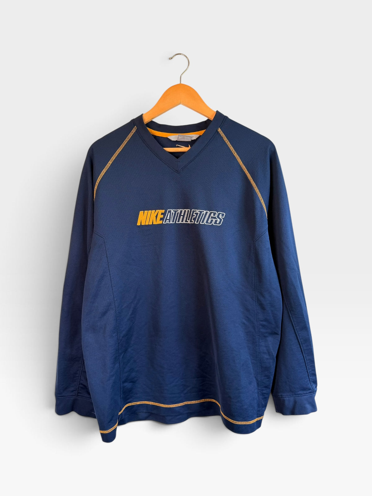 225 Threadz navy blue Nike Athletics long sleeve performance pullover with gold contrast stitching and V-neck design