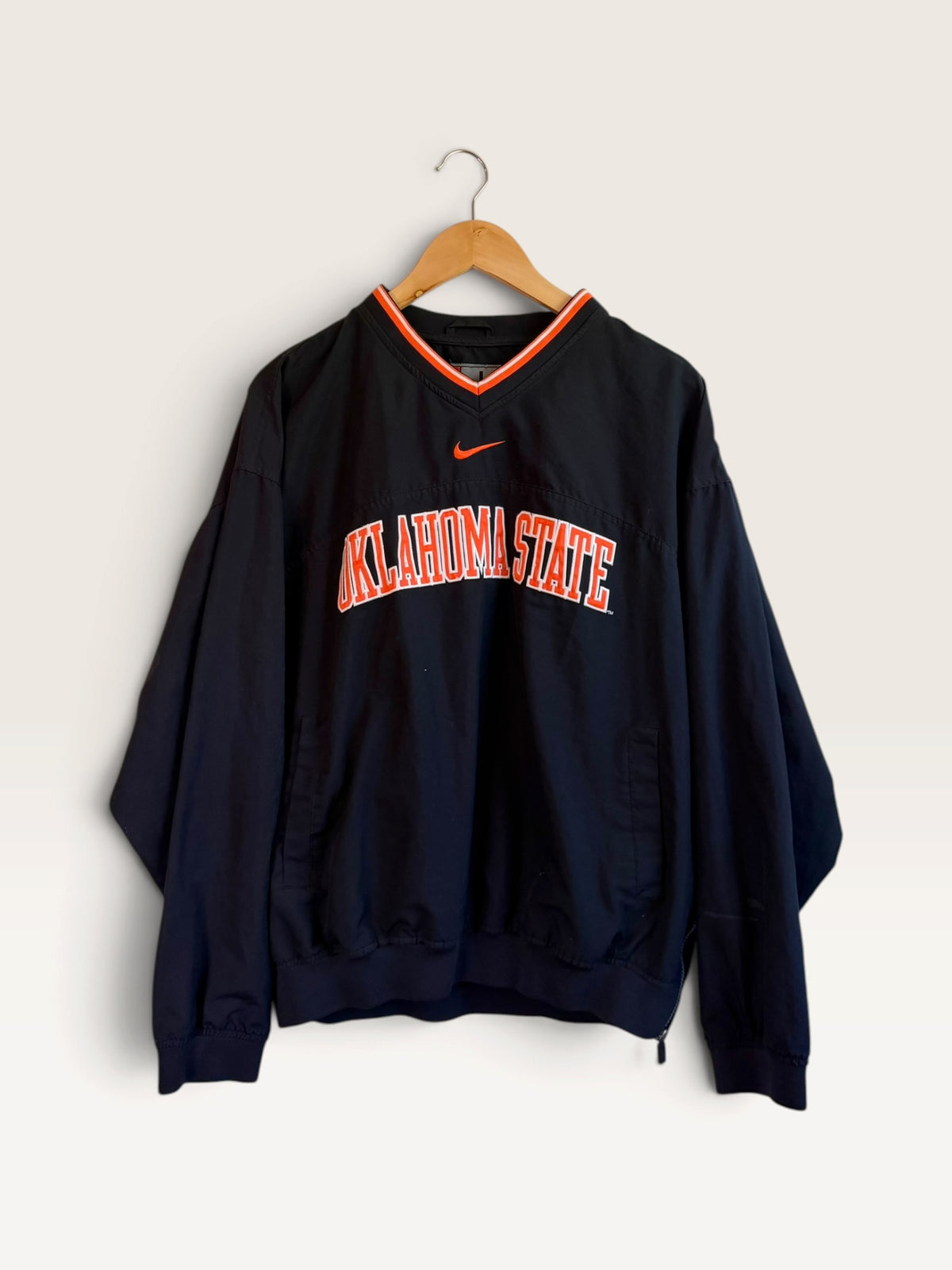225 Threadz Oklahoma State Nike black pullover windbreaker with orange and white V-neck trim and team branding.