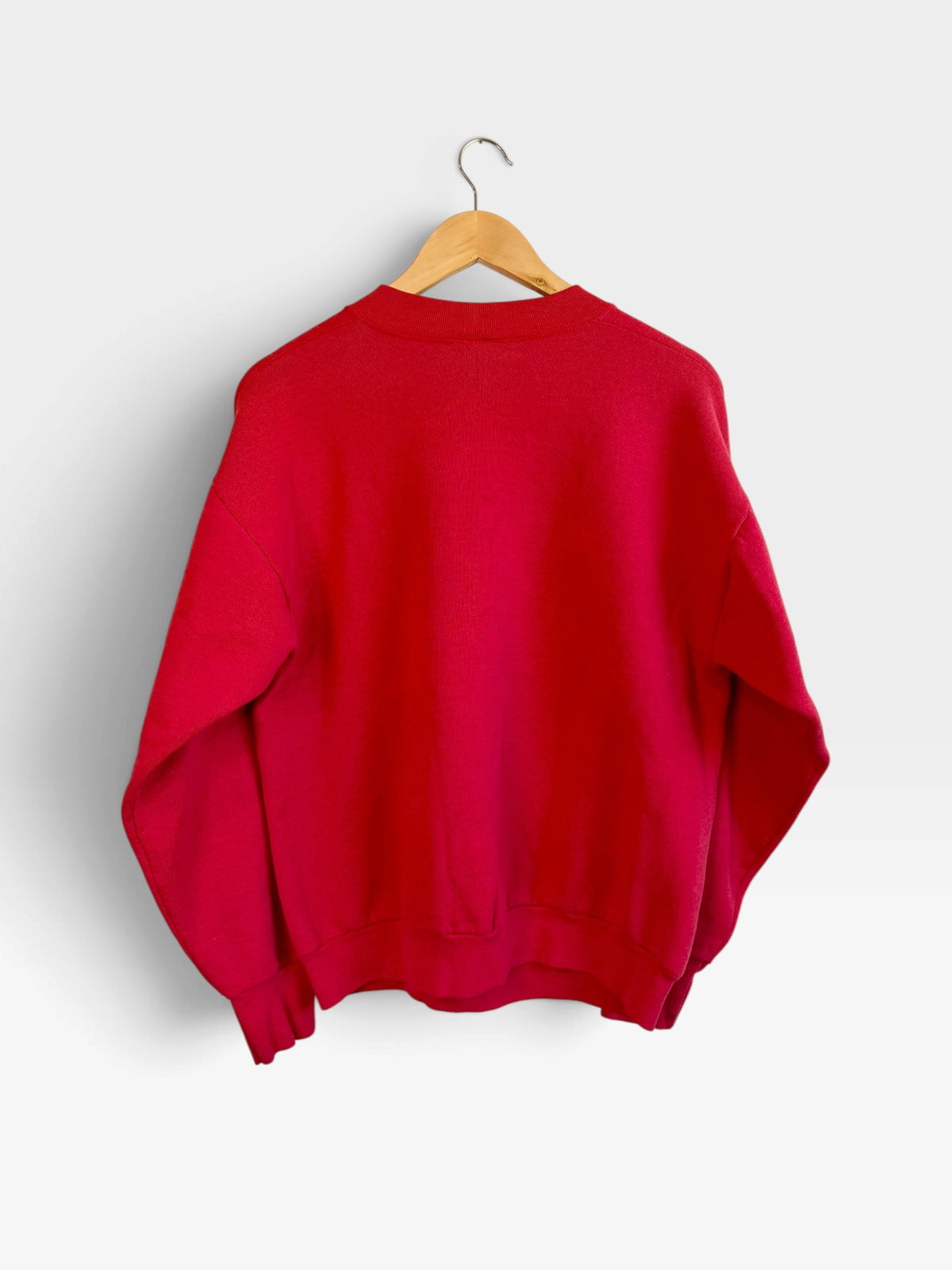Back view of a 225 Threadz red crewneck sweatshirt hanging on a wooden hanger against a plain white background.