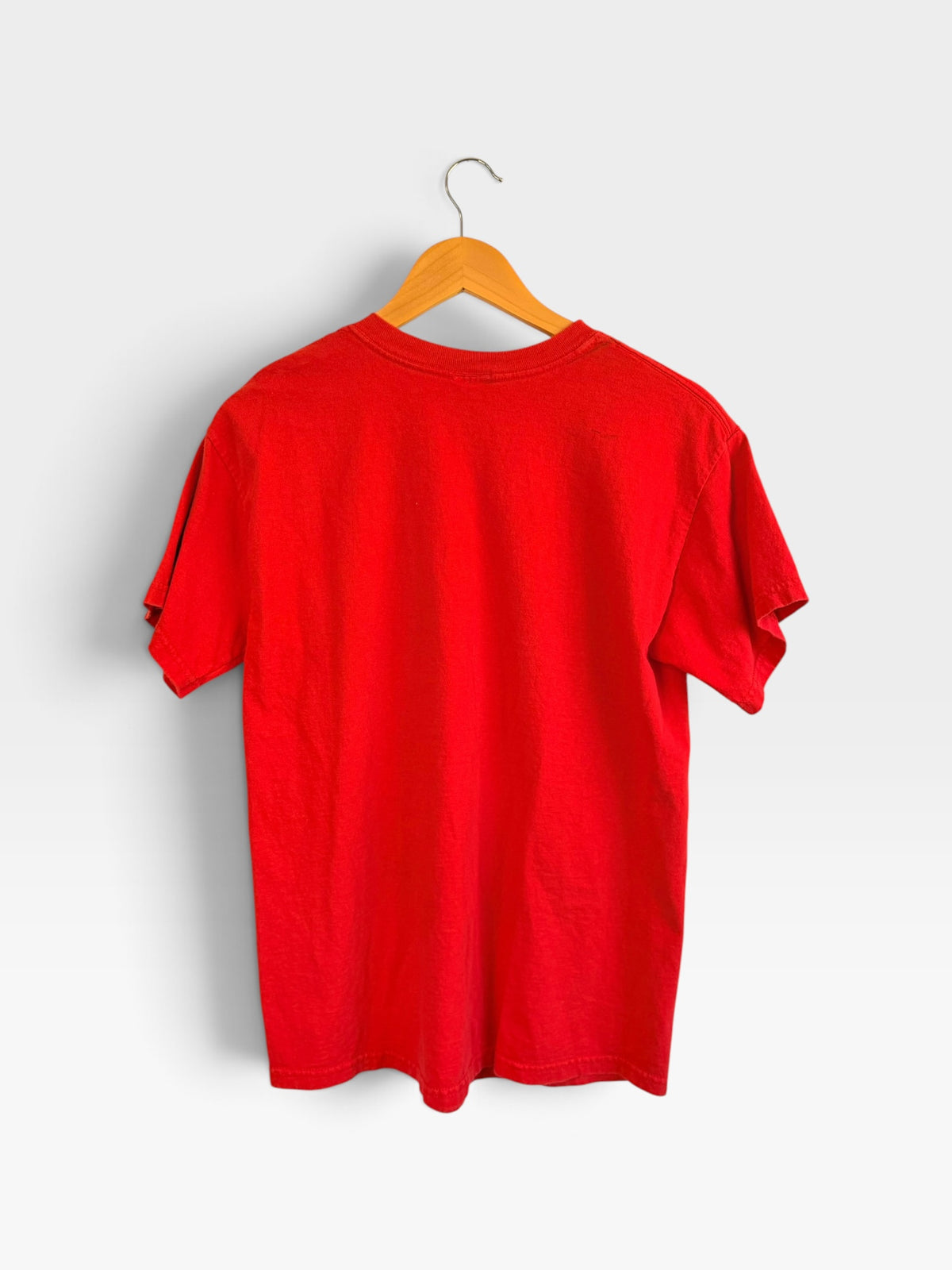 Back view of a plain red 225 Threadz vintage Kansas City Chiefs graphic t-shirt hanging on a wooden hanger.