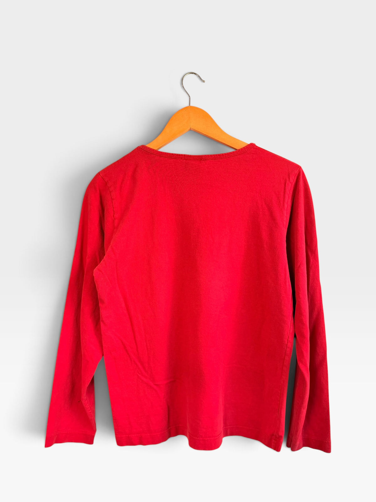 225 Threadz red long sleeve crewneck shirt hanging on a wooden hanger against a plain background