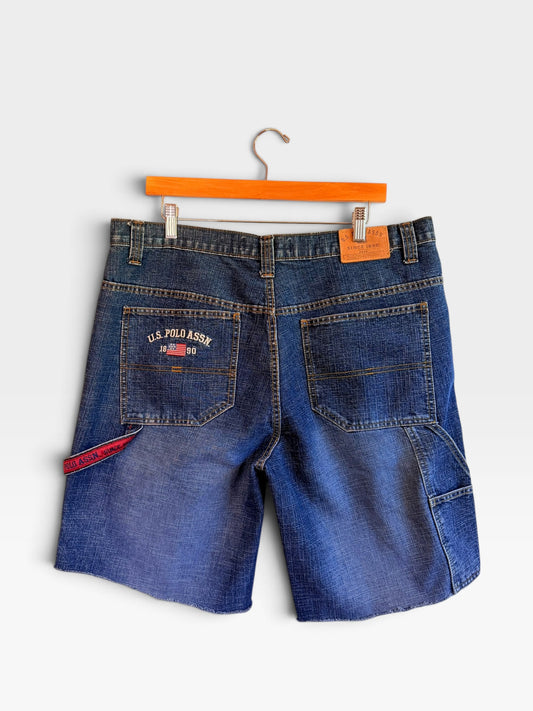 225 Threadz U.S. POLO ASSN. medium-wash denim carpenter shorts with utility loop, raw hem, and back pocket embroidery.