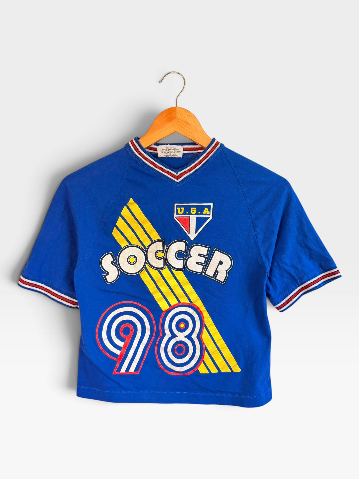 225 Threadz vintage blue cotton soccer t-shirt with 98 graphic, V-neck, and red, white, and blue striped trim.