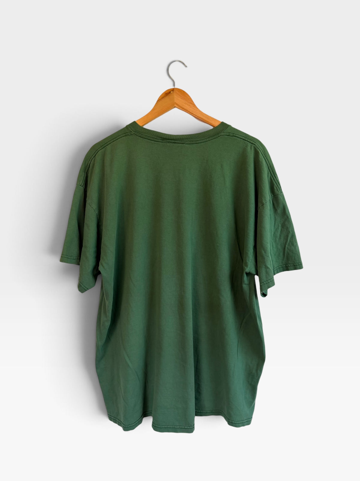 225 Threadz vintage forest green Nike short sleeve cotton t-shirt hanging on a wooden hanger, back view.
