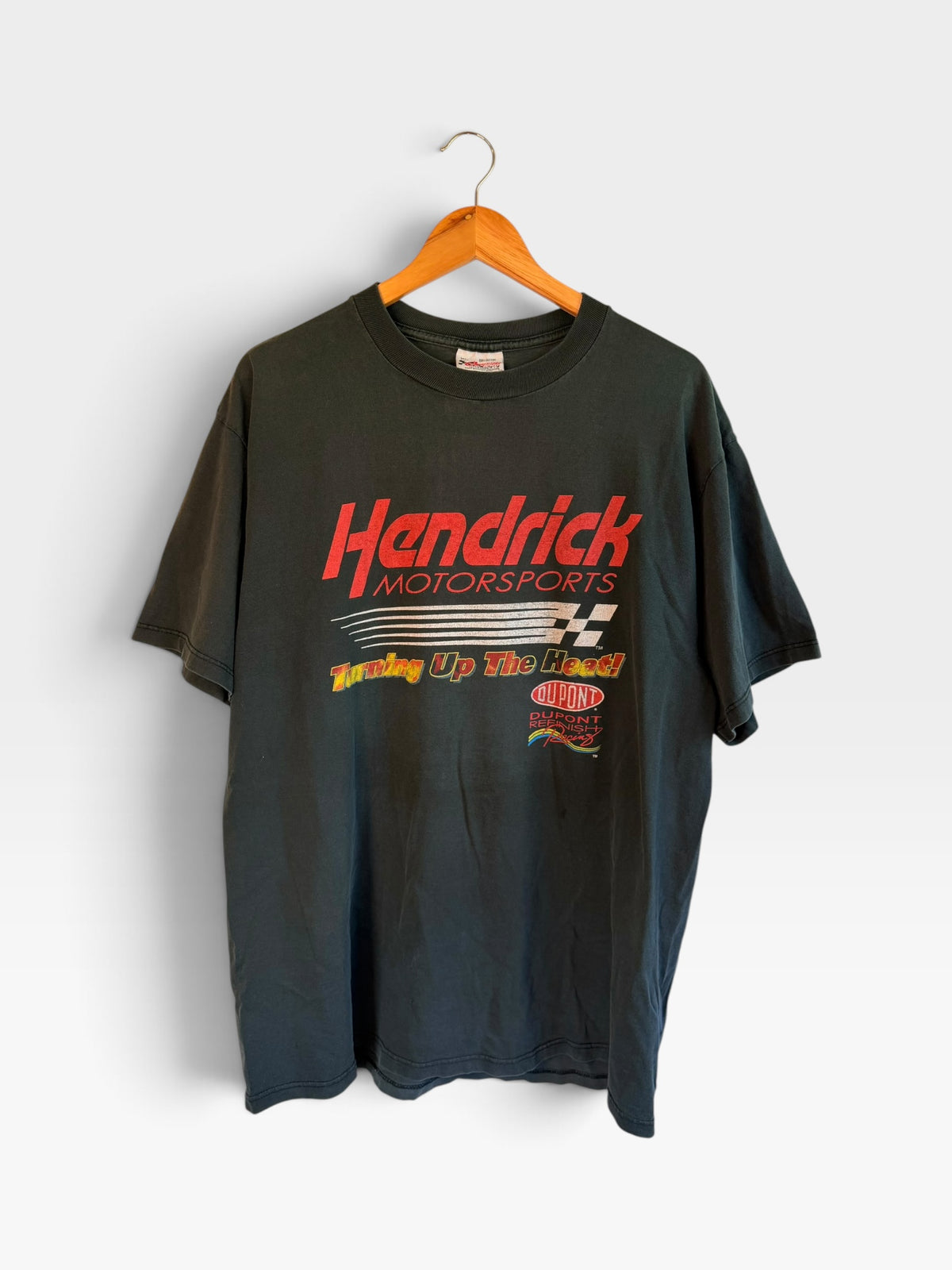 225 Threadz vintage black Hendrick Motorsports racing t-shirt with Turning Up The Heat graphic on a wooden hanger