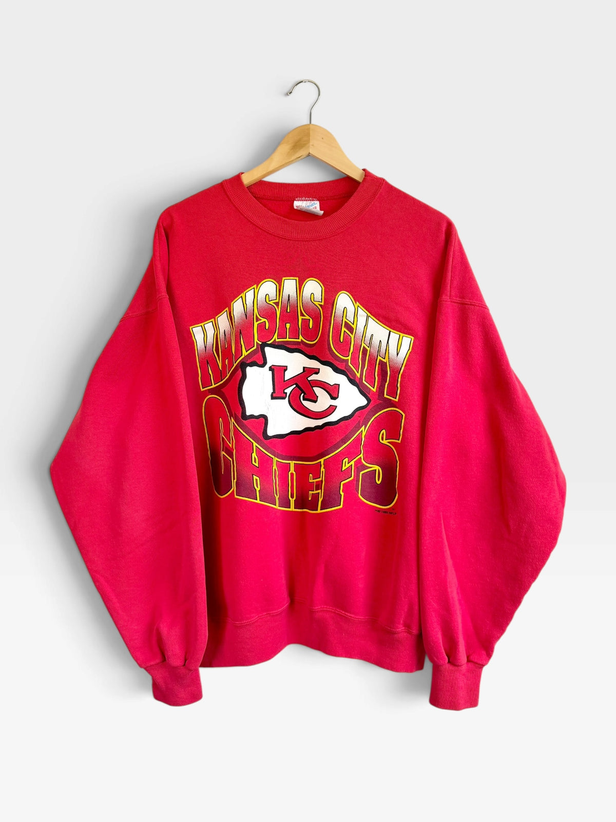 225 Threadz vintage red Kansas City Chiefs crewneck sweatshirt with bold team graphic and ribbed cuffs on a hanger