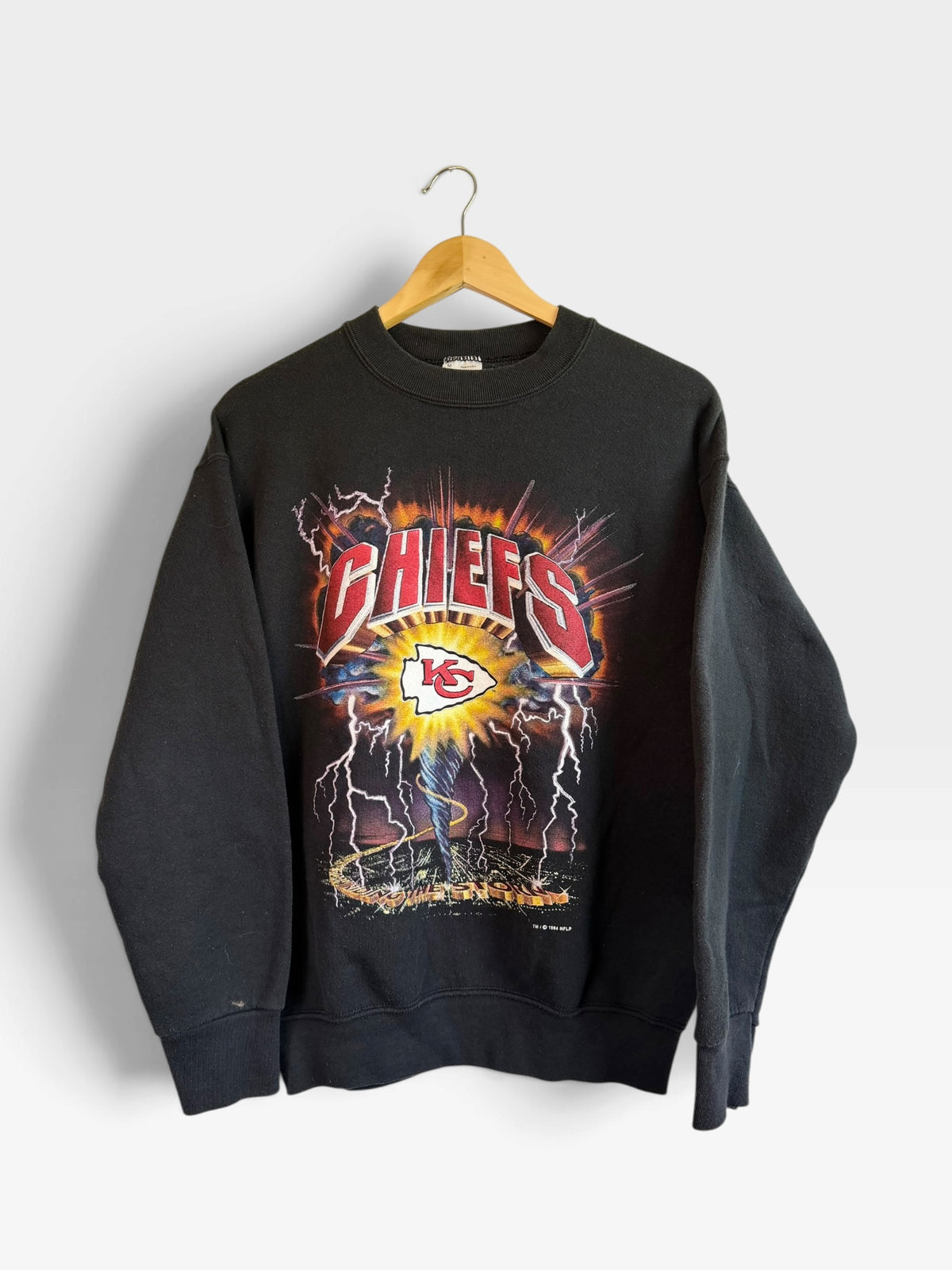 225 Threadz vintage black Kansas City Chiefs crewneck sweatshirt with a bold lightning graphic print on the front.