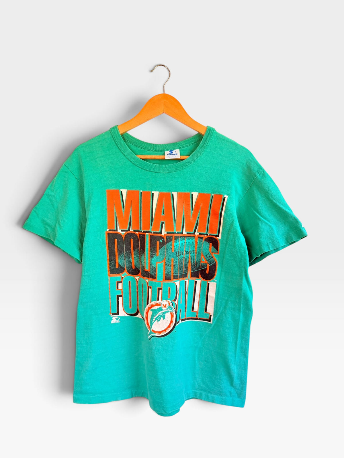 225 Threadz vintage green Miami Dolphins NFL graphic t-shirt with Starter branding on a wooden hanger