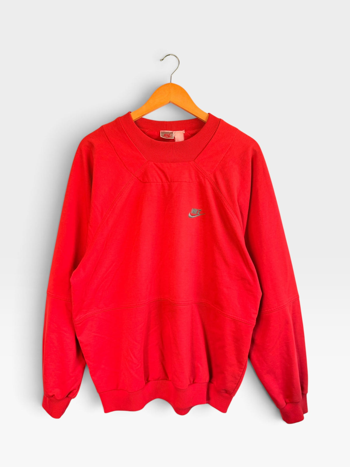 225 Threadz vintage red Nike crewneck sweatshirt with structured chest paneling and embroidered logo on a hanger