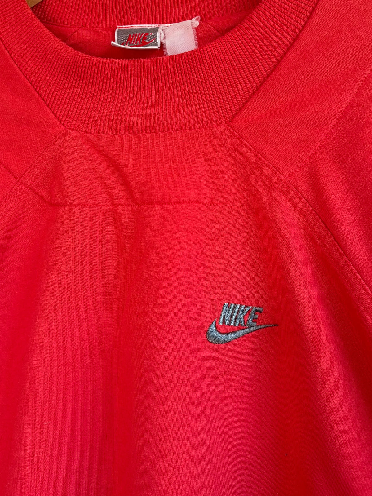 225 Threadz vintage red Nike crewneck sweatshirt with structured chest paneling and embroidered logo detail.