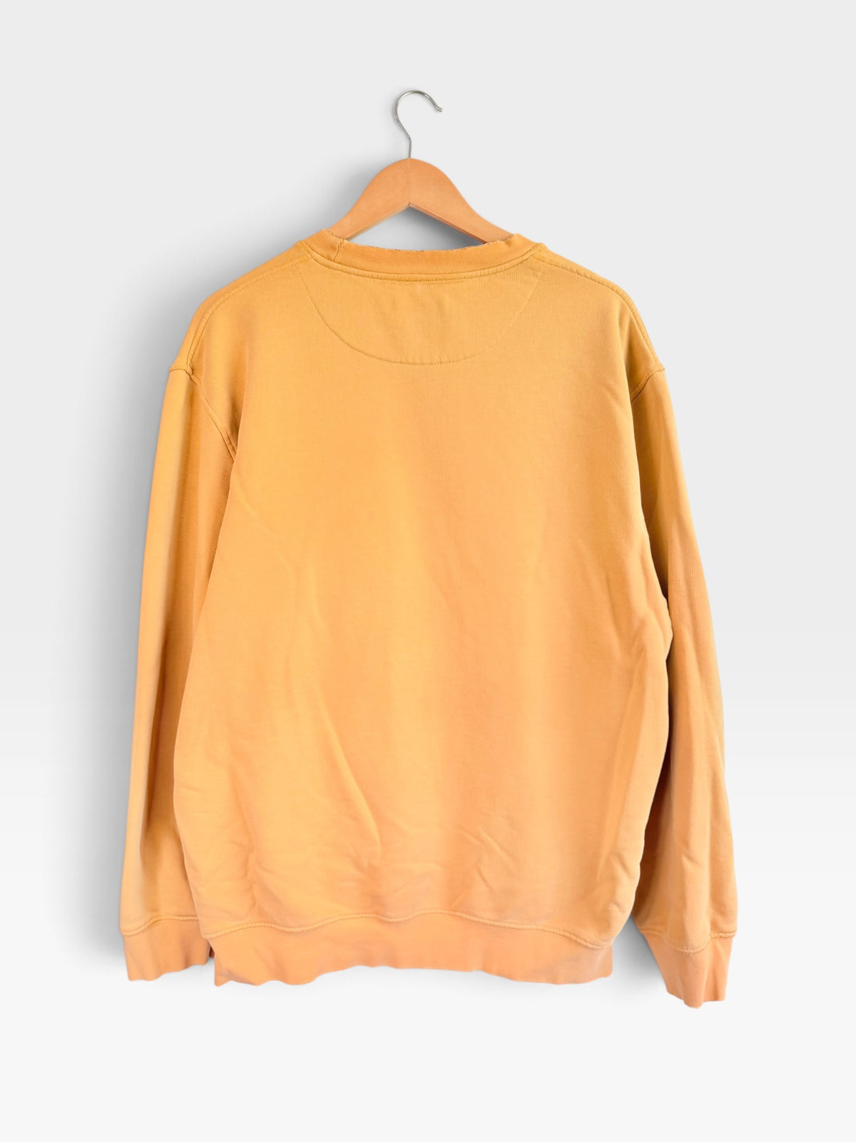 225 Threadz sun-washed yellow Nike crewneck sweatshirt hanging on a wooden hanger against a plain white background.